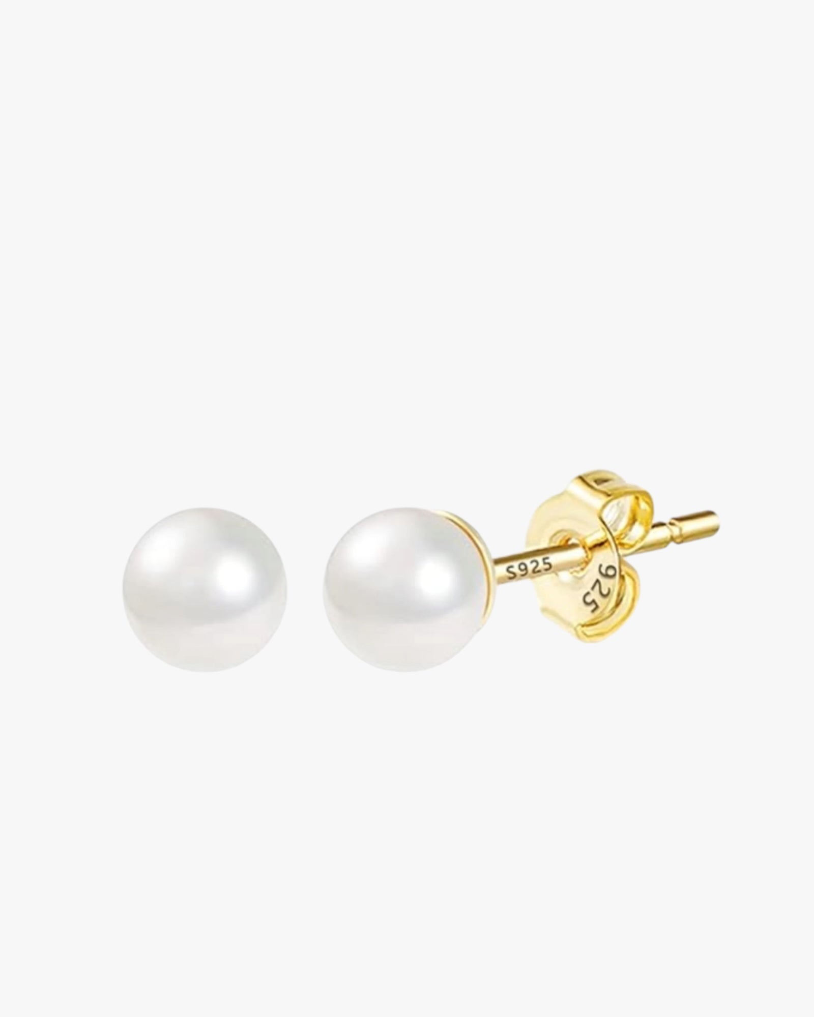 A pair of gold-plated stud earrings with a white pearl-like bead and a yellow gold-plated band.