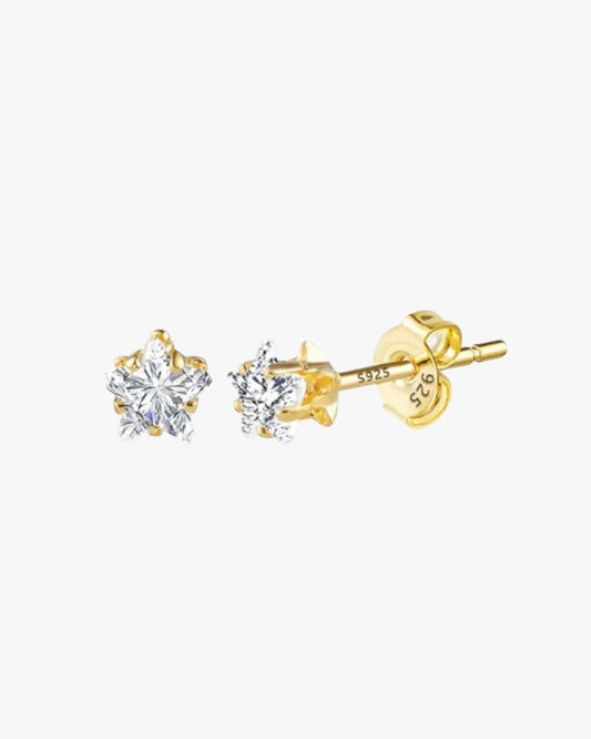A pair of gold-colored stud earrings with clear embellishments on a white background