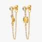 Gold earrings with chain and celestial design on a white background