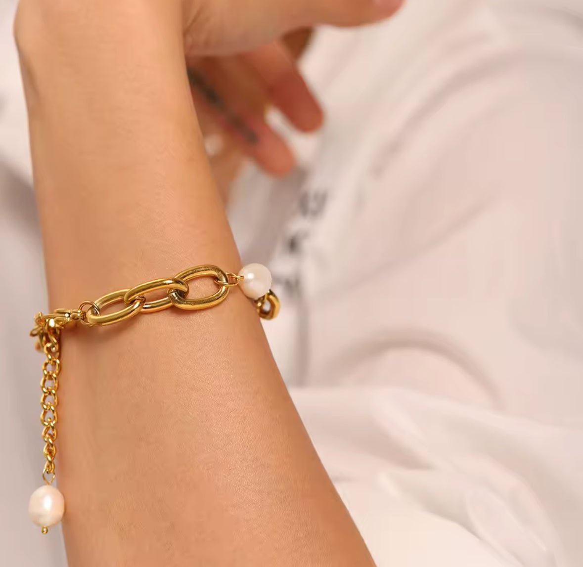 Minimalist gold plated stainless steel bracelet with adjustable extension chain on arm