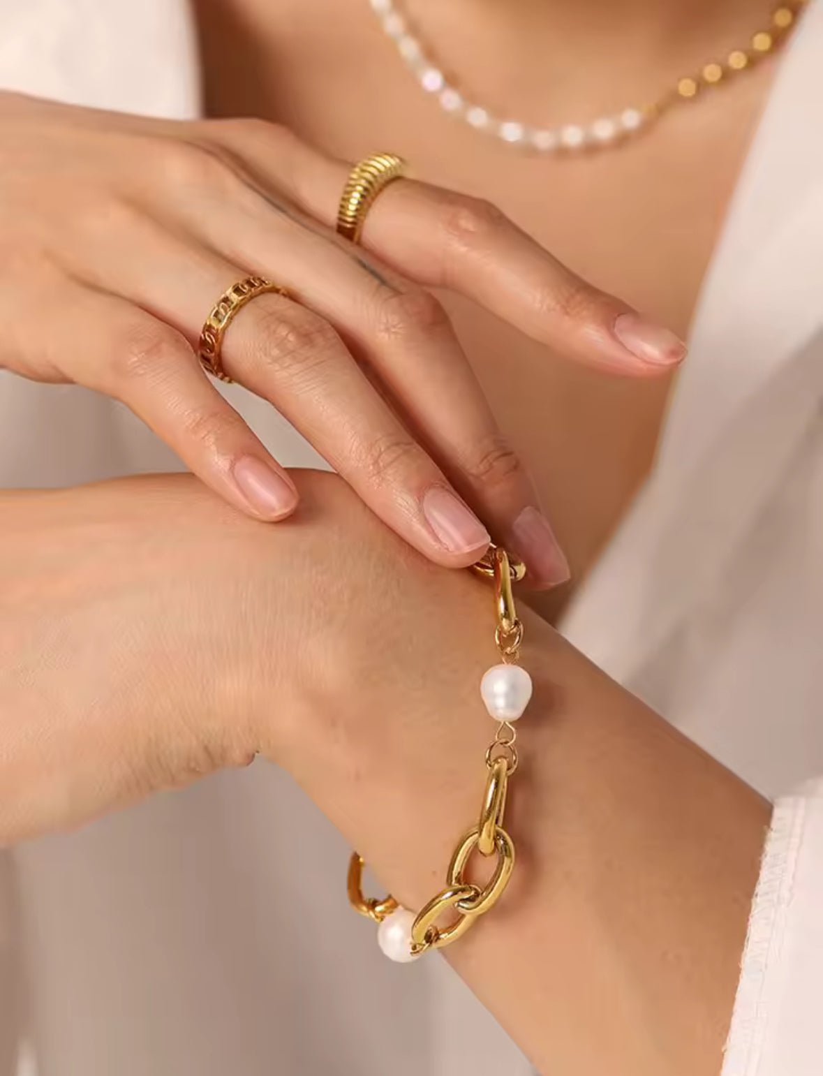 Minimalist gold plated stainless steel bracelet with adjustable extension chain on arm