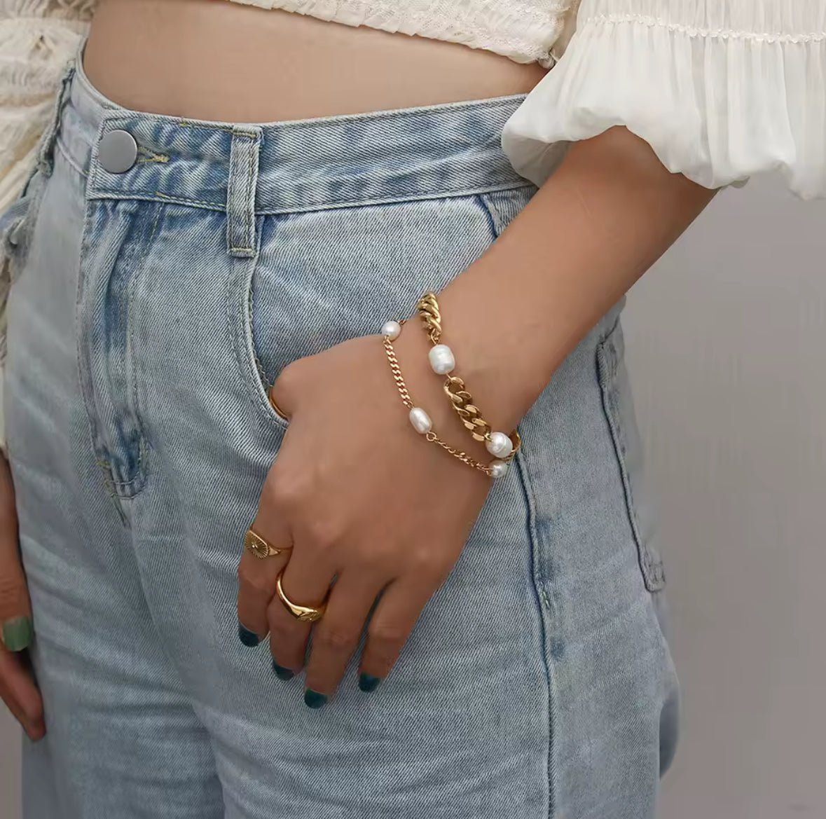 Minimalist gold plated stainless steel bracelet with adjustable extension chain on arm