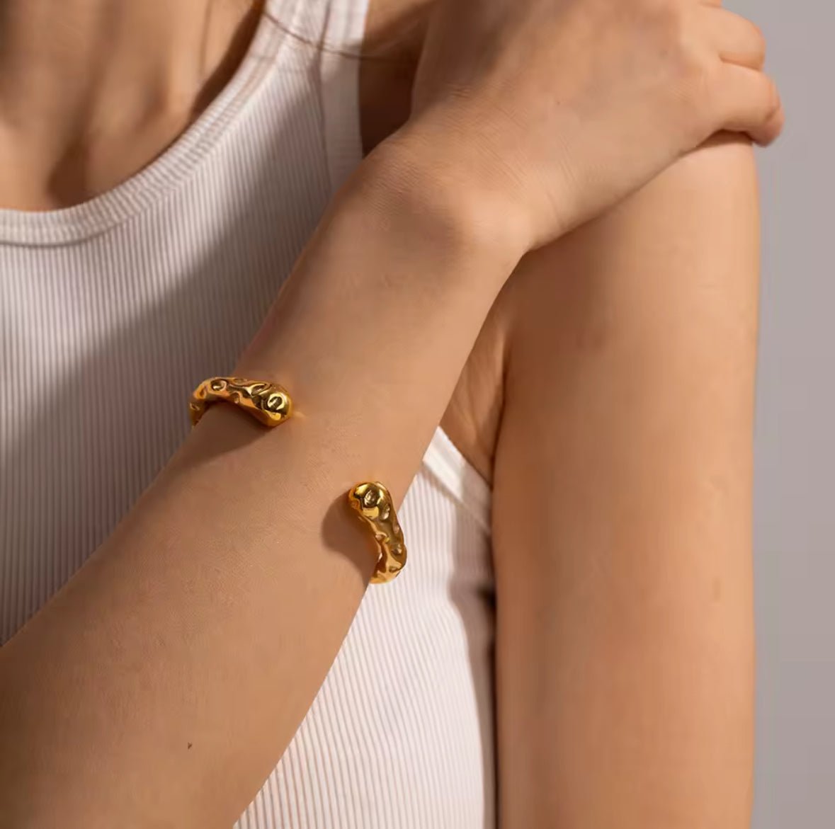 Aurea hammered gold bangle bracelet with 18K gold plated stainless steel statement design