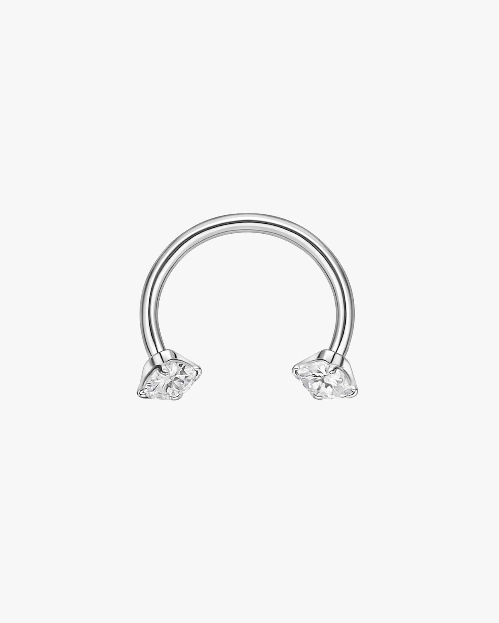 Gold double hoop earring in ear with marquise crystals in silver