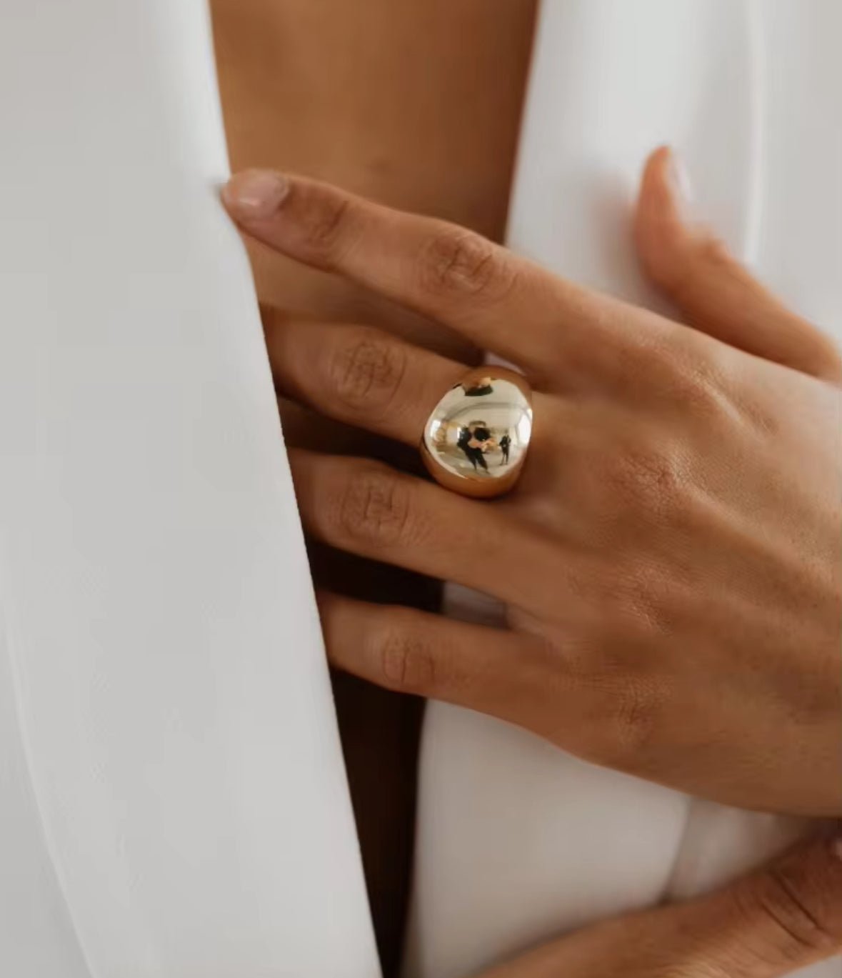 Gold plated dome statement ring on a finger